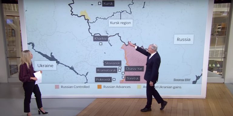 Due conduttori in uno studio televisivo mostrano sulla mappa l'area nel Kursk in Russia occupata dalle forze militari ucraine.